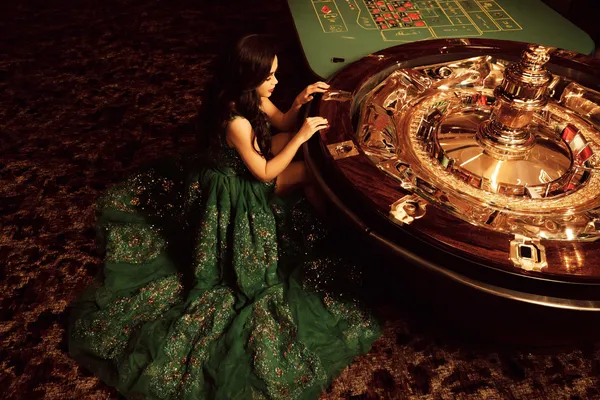 A glamorous woman holding casino chips in a neon-lit environment, representing the premium online casino atmosphere of 778G0.